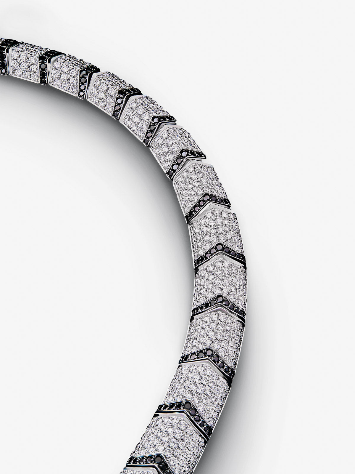 Collar rígido con forma de tigre de oro blanco de 18K con diamantes blancos y negros en talla brillante con un total de 22,7 cts y 2 esmeraldas en talla trapecio con un total de 0,13 cts