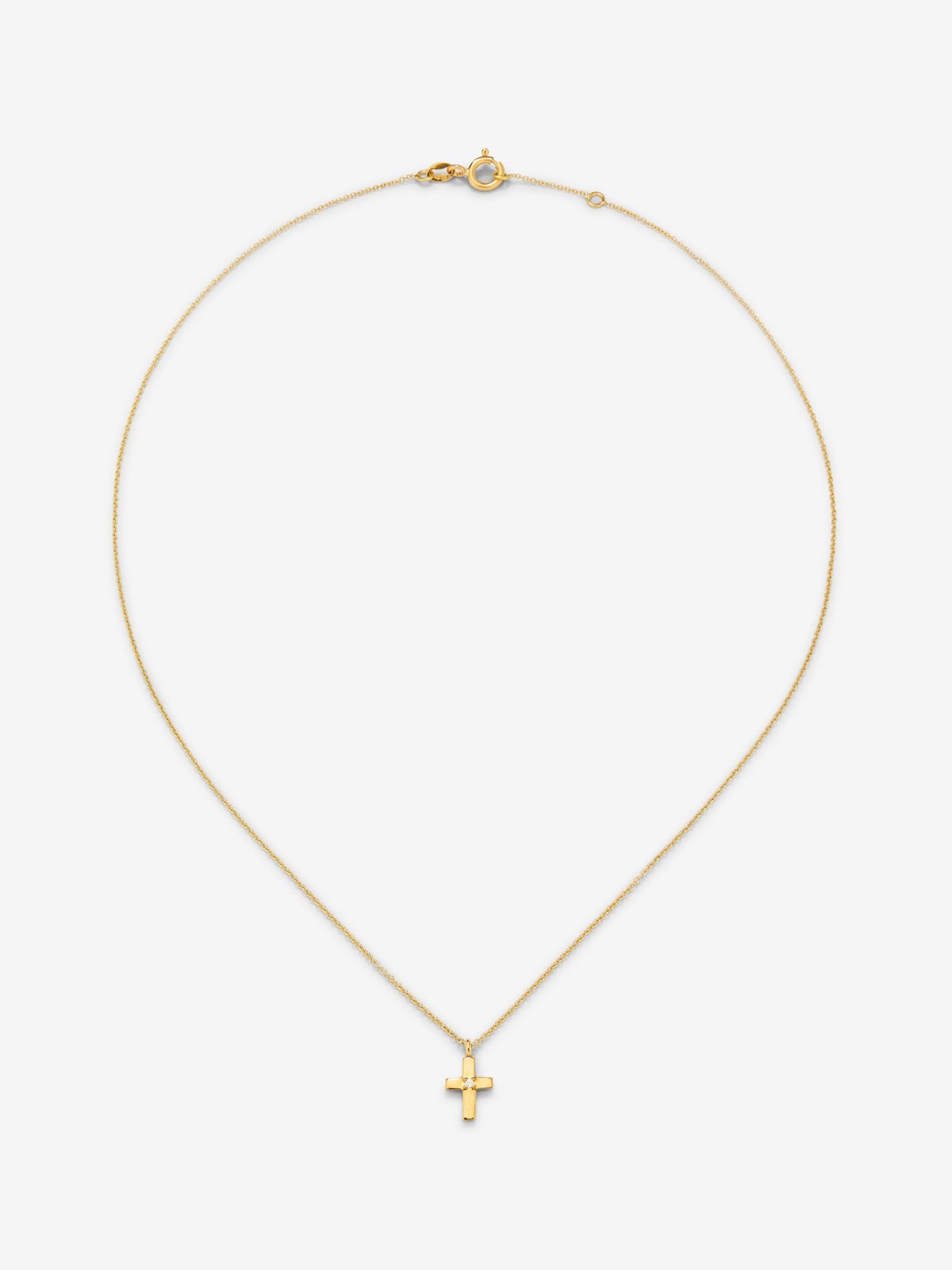 Colgante de oro amarillo de 18K con cruz pequeña y diamante en talla brillante de 0,01 cts