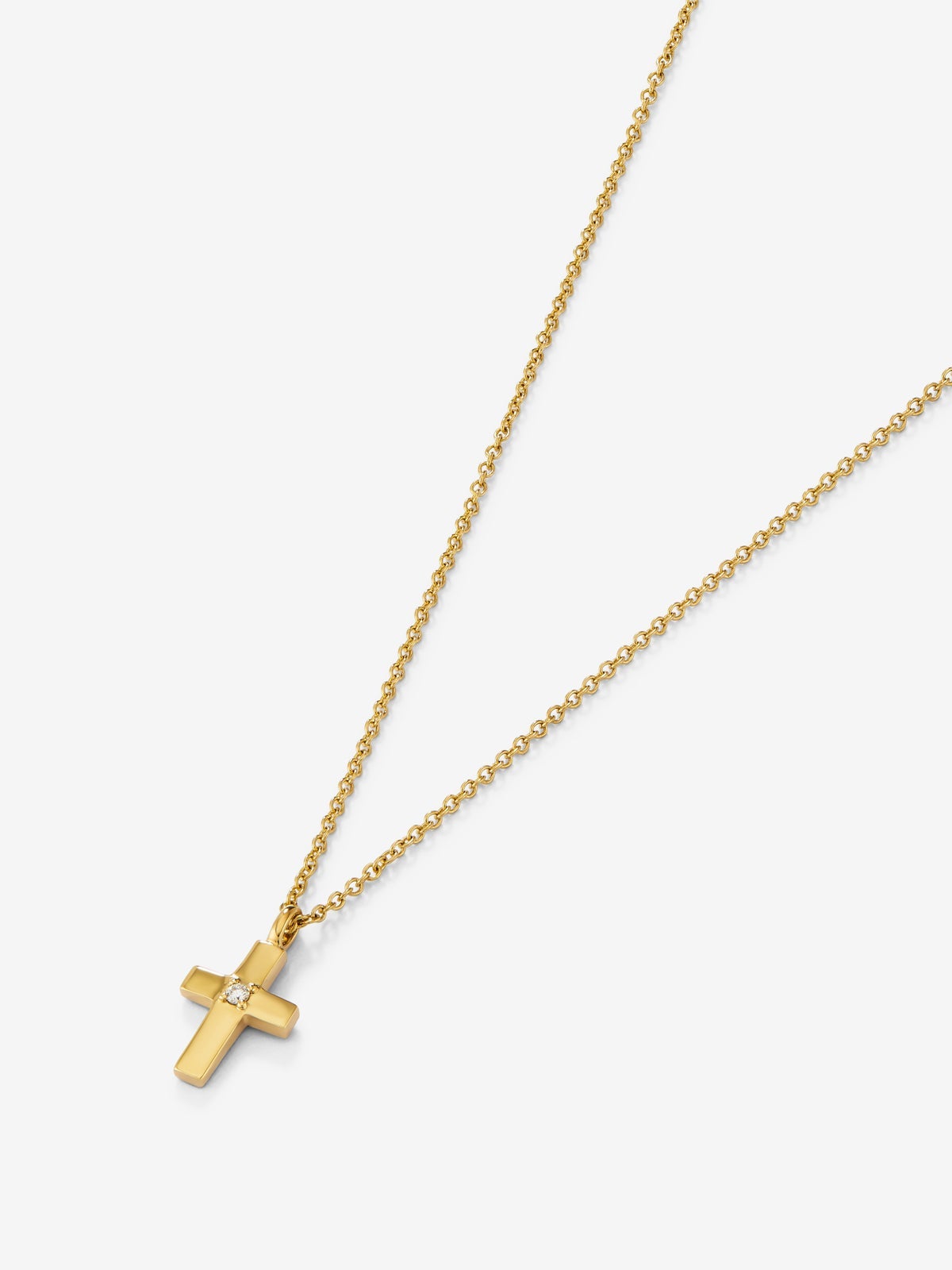 Colgante de oro amarillo de 18K con cruz pequeña y diamante en talla brillante de 0,01 cts