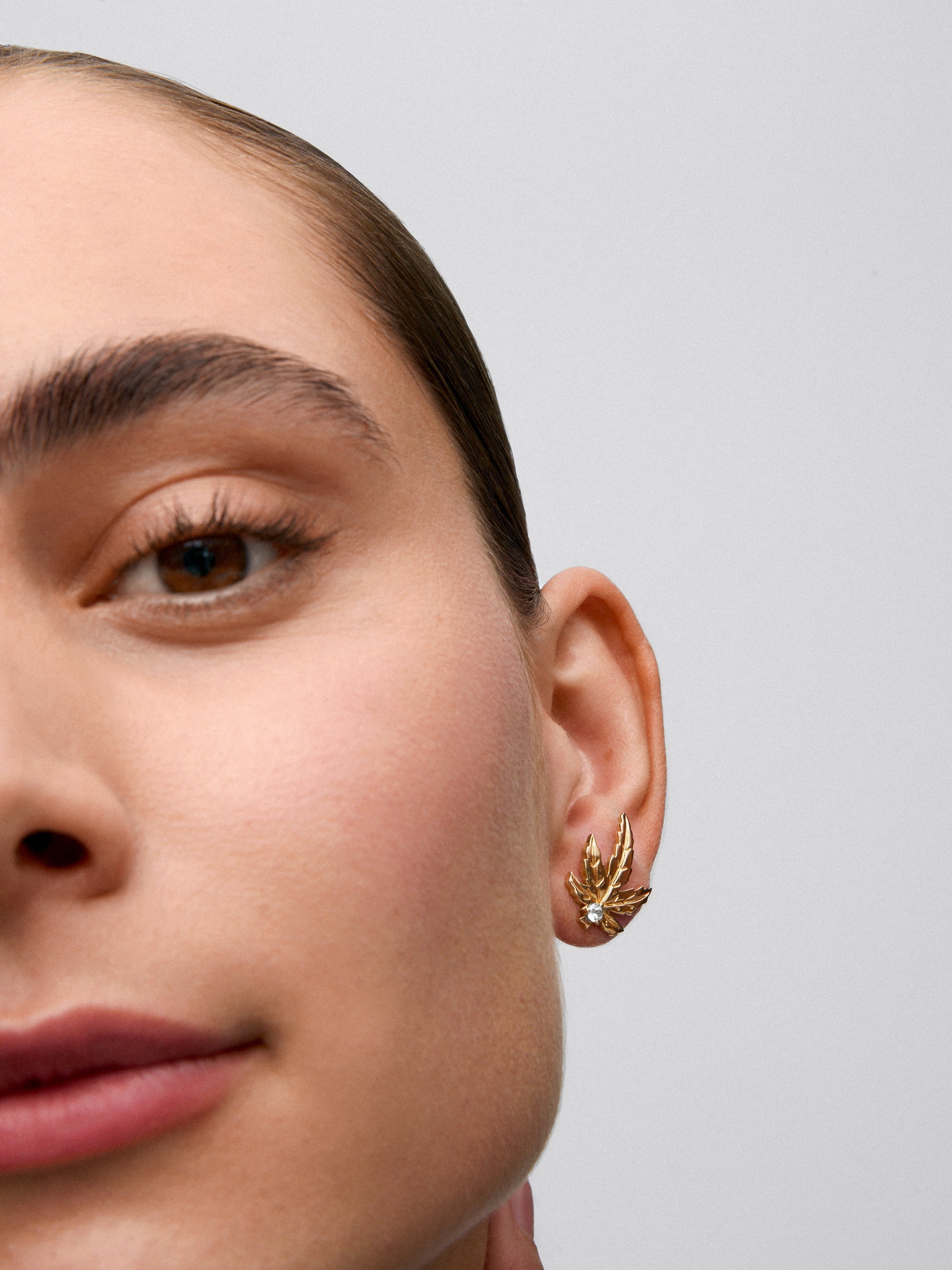 Pendientes de oro amarillo de 18K con 2 diamantes centrales con un total de 0,17 cts y forma de hojas de arce