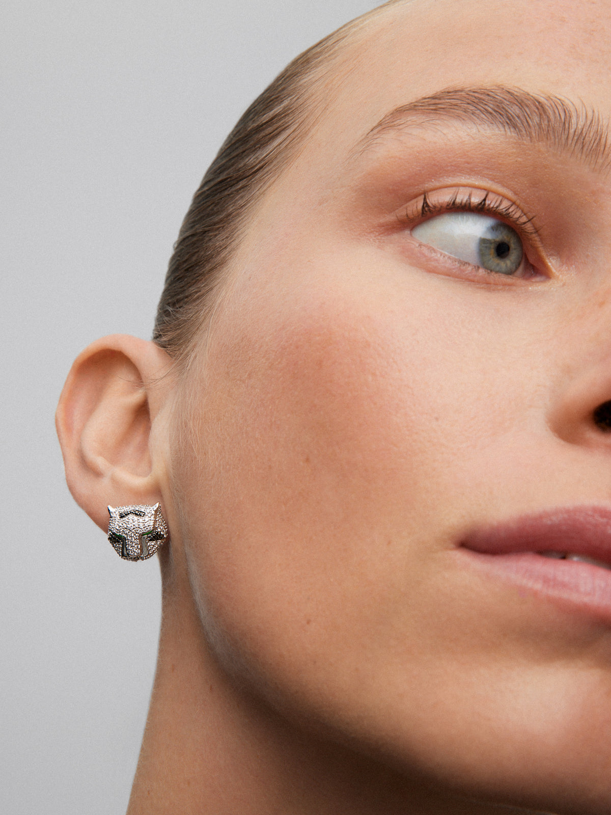 Pendientes con forma de tigre de oro blanco de 18K con diamantes blancos y negros en talla brillante con un total de 3,15 cts, y esmeraldas en talla trapecio con un total de 0,26 cts
