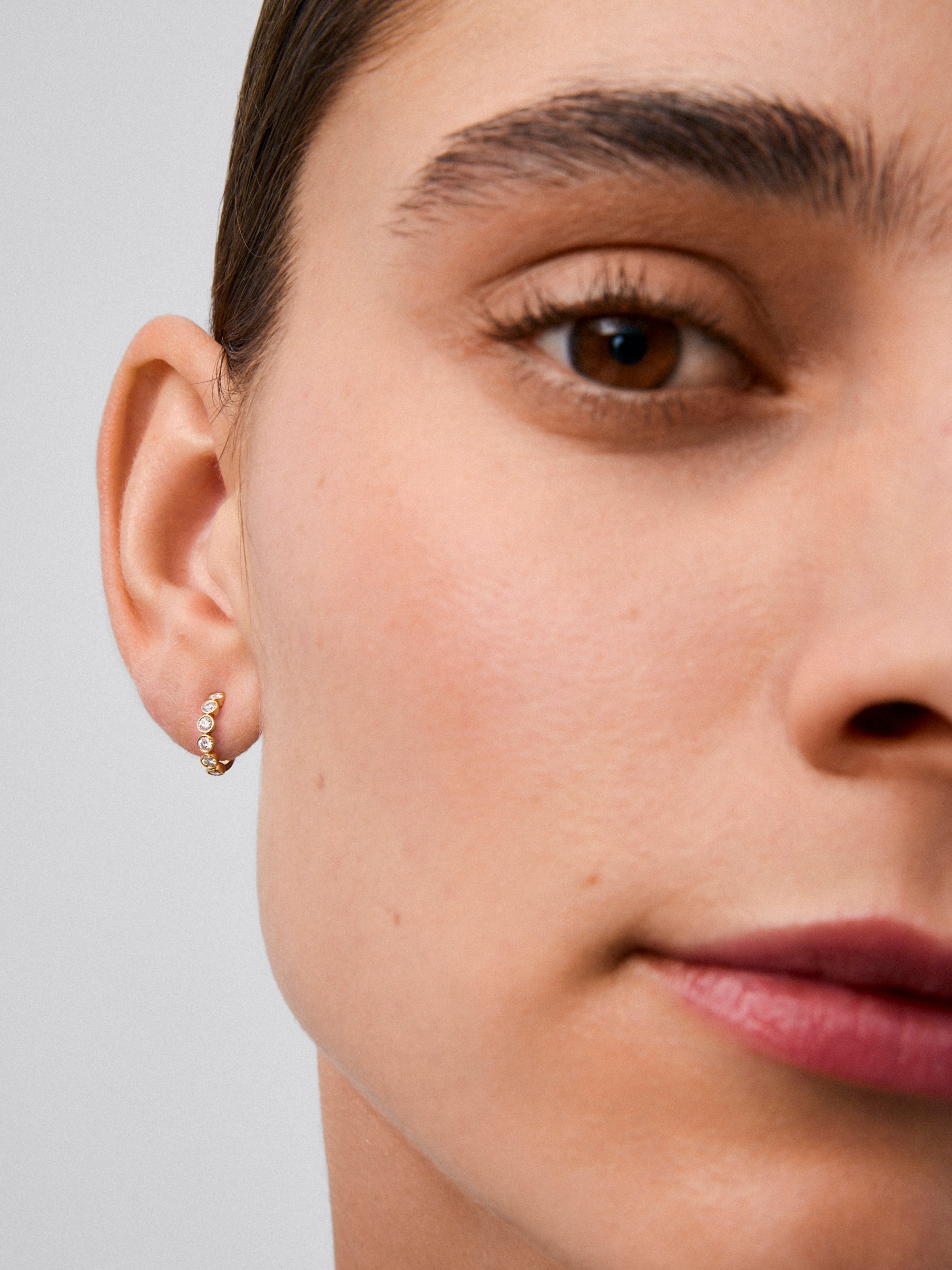 Pendientes de aro en oro amarillo de 18K con 12 diamantes en talla brillante con un total de 0,3 cts