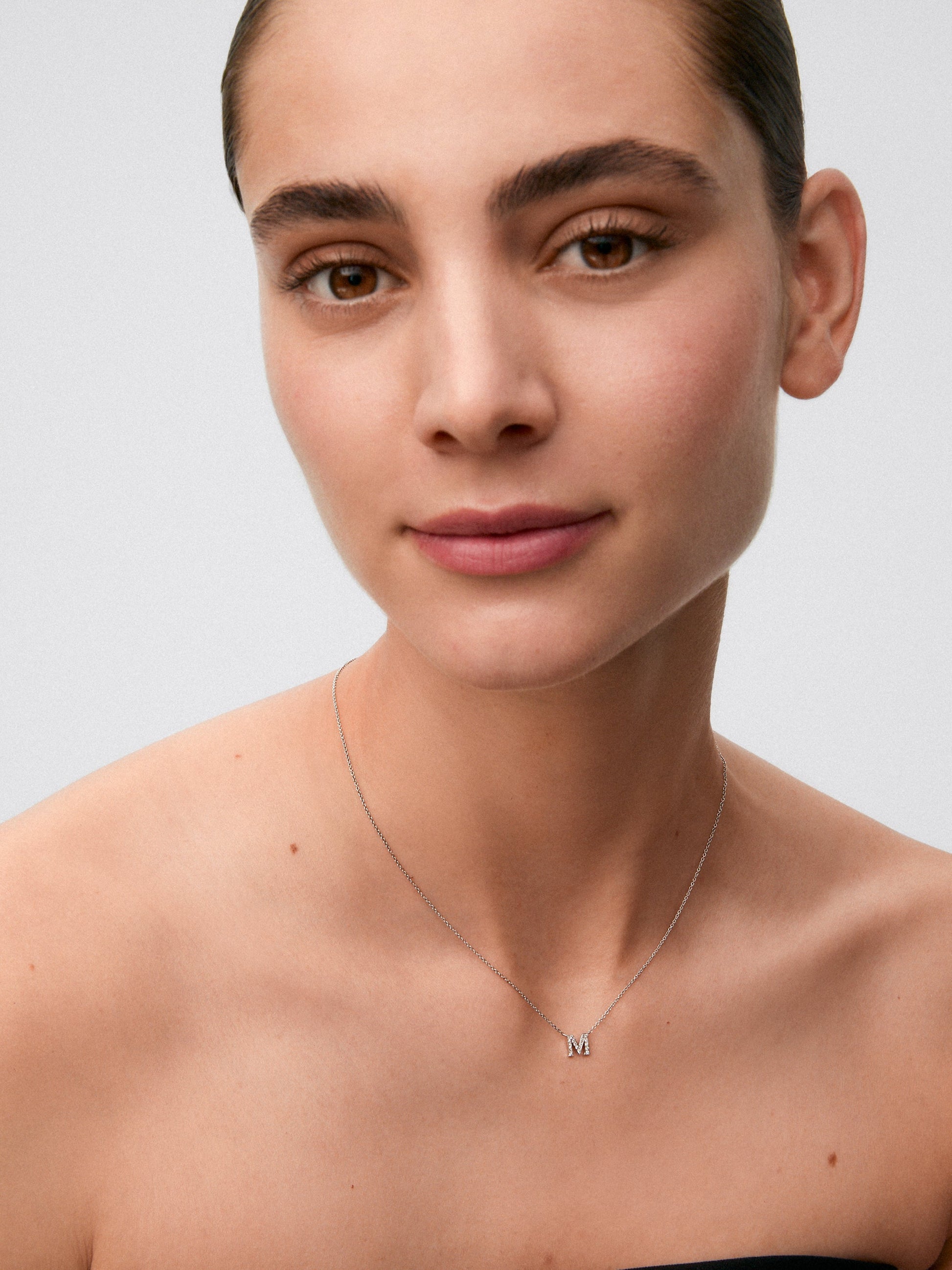 Colgante cadena con inicial pequeña de oro blanco de 18K y diamantes
