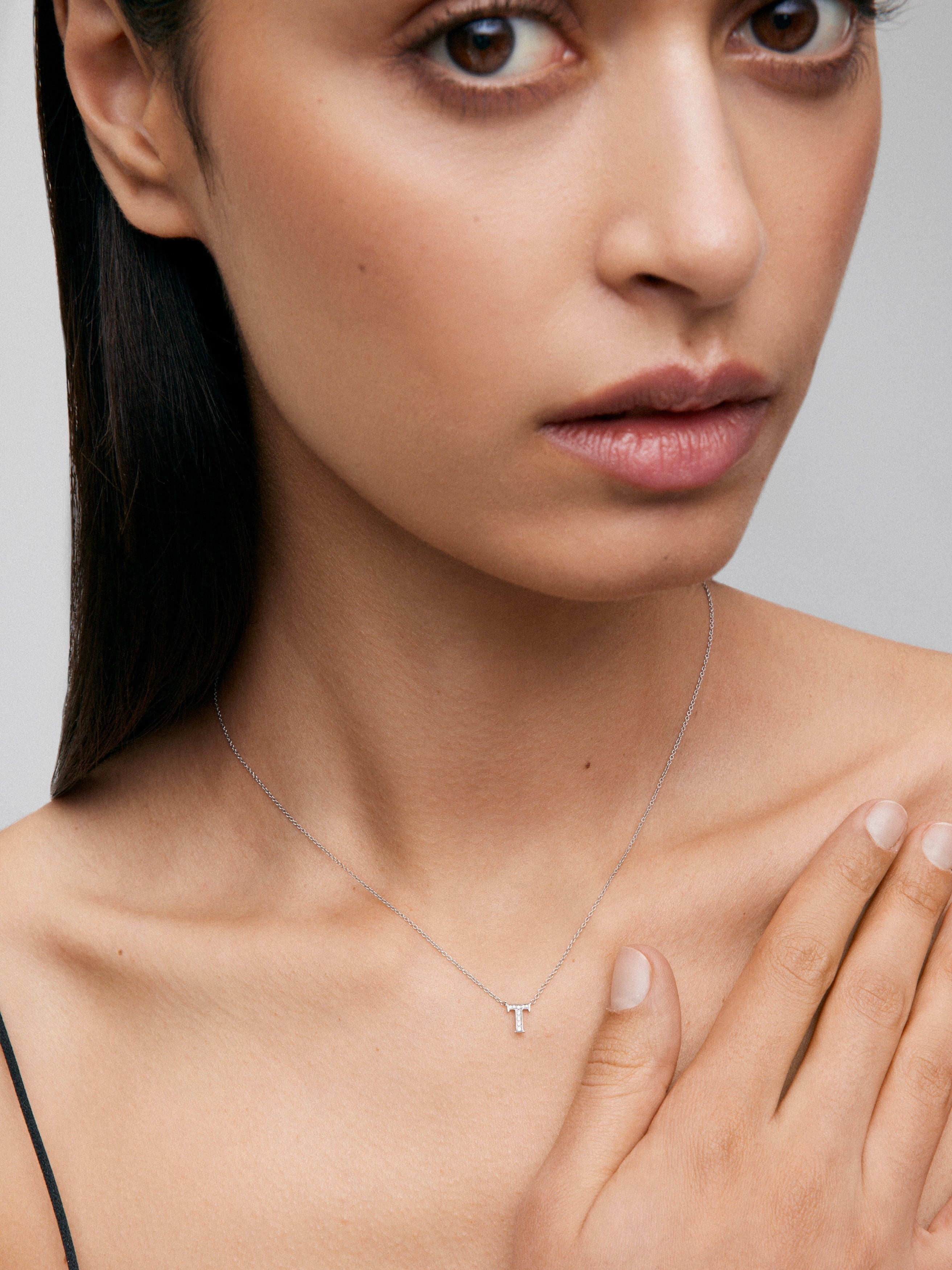 Colgante de oro blanco de 18K con letra T en pavé de 10 diamantes en talla brillante con un total de 0,0205 cts