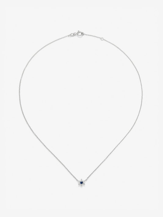 Colgante de oro blanco de 18K con zafiro azul en talla brillante de 0,1 cts y 6 diamantes en talla brillante con un total de 0,12 cts en forma de estrella