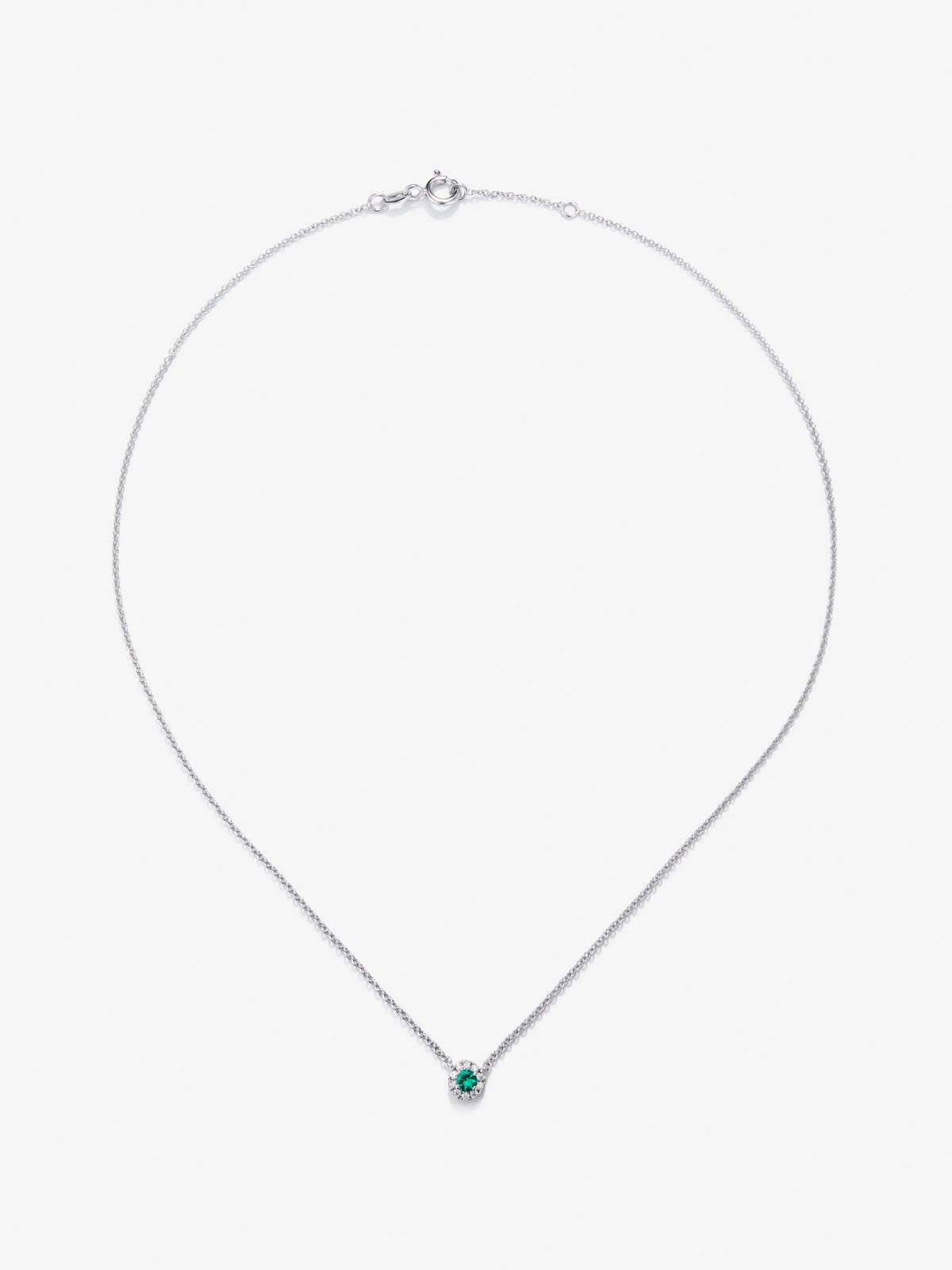 Colgante de oro blanco de 18K con esmeralda en talla brillante de 0,255 cts y diamantes en talla brillante de 0,086 cts