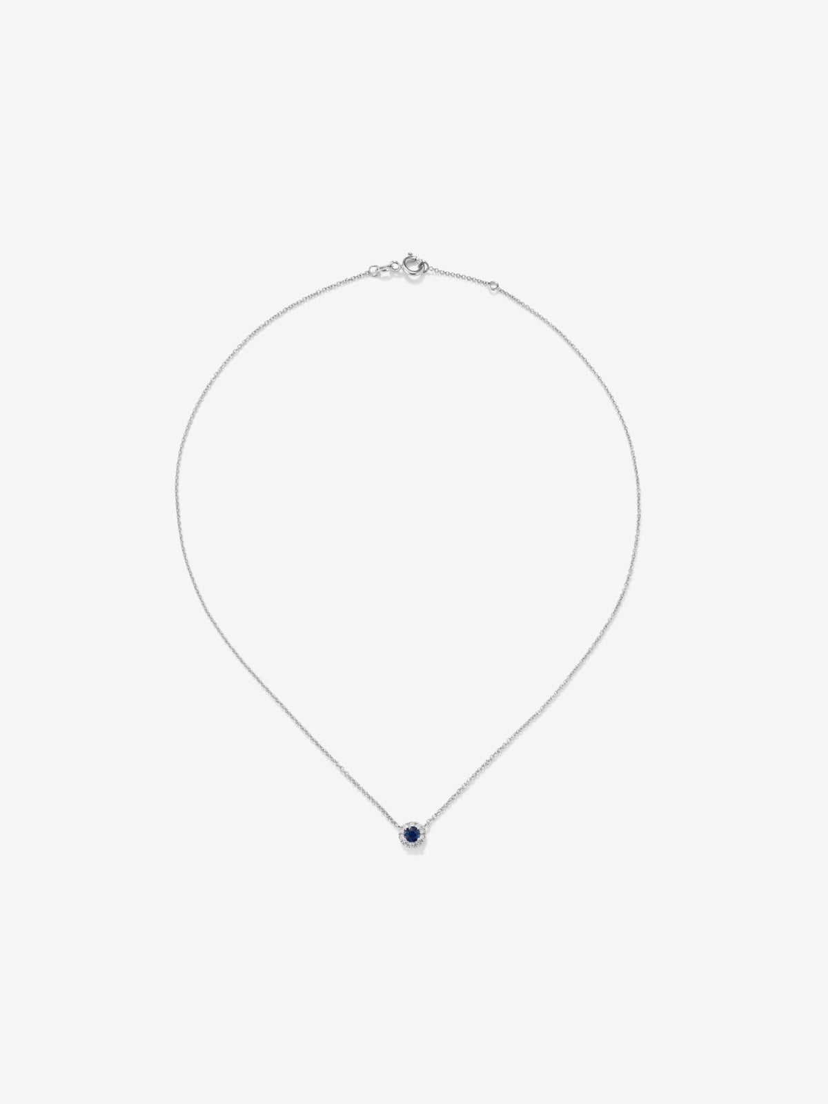 Colgante de oro blanco de 18K con zafiro azul en talla brillante de 0,2 cts y diamantes en talla brillante de 0,05 cts