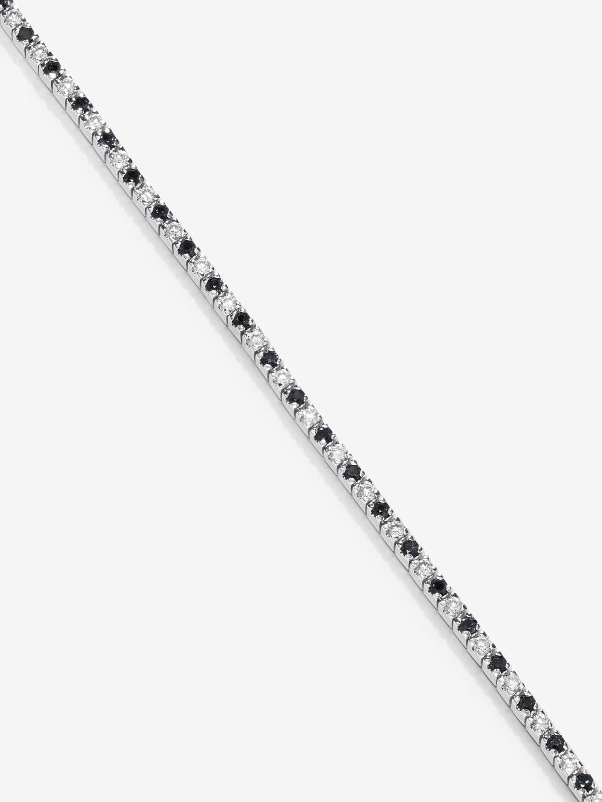 Pulsera riviere de oro blanco de 18K con diamante negro y diamante blanco