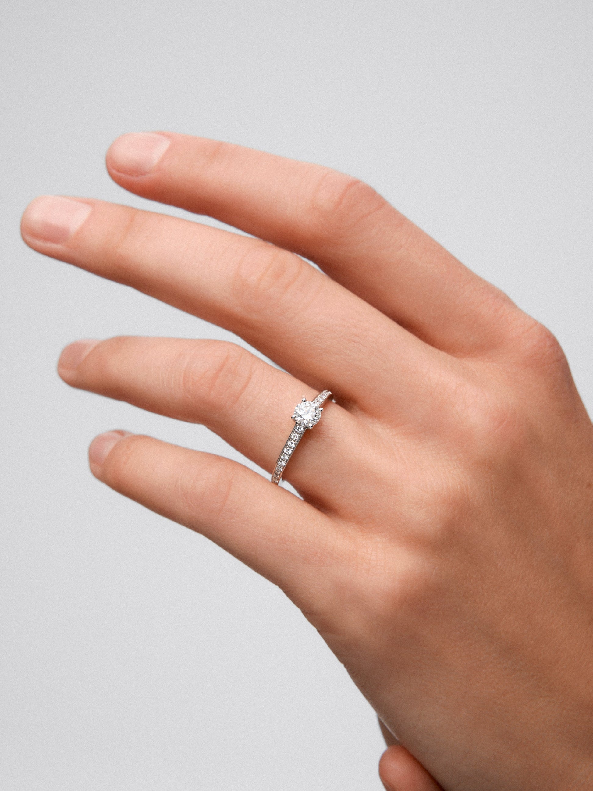 Anillo solitario de oro blanco de 18K con diamante central de 0,40 cts y diamantes en talla brillante con un total de 0,17 cts