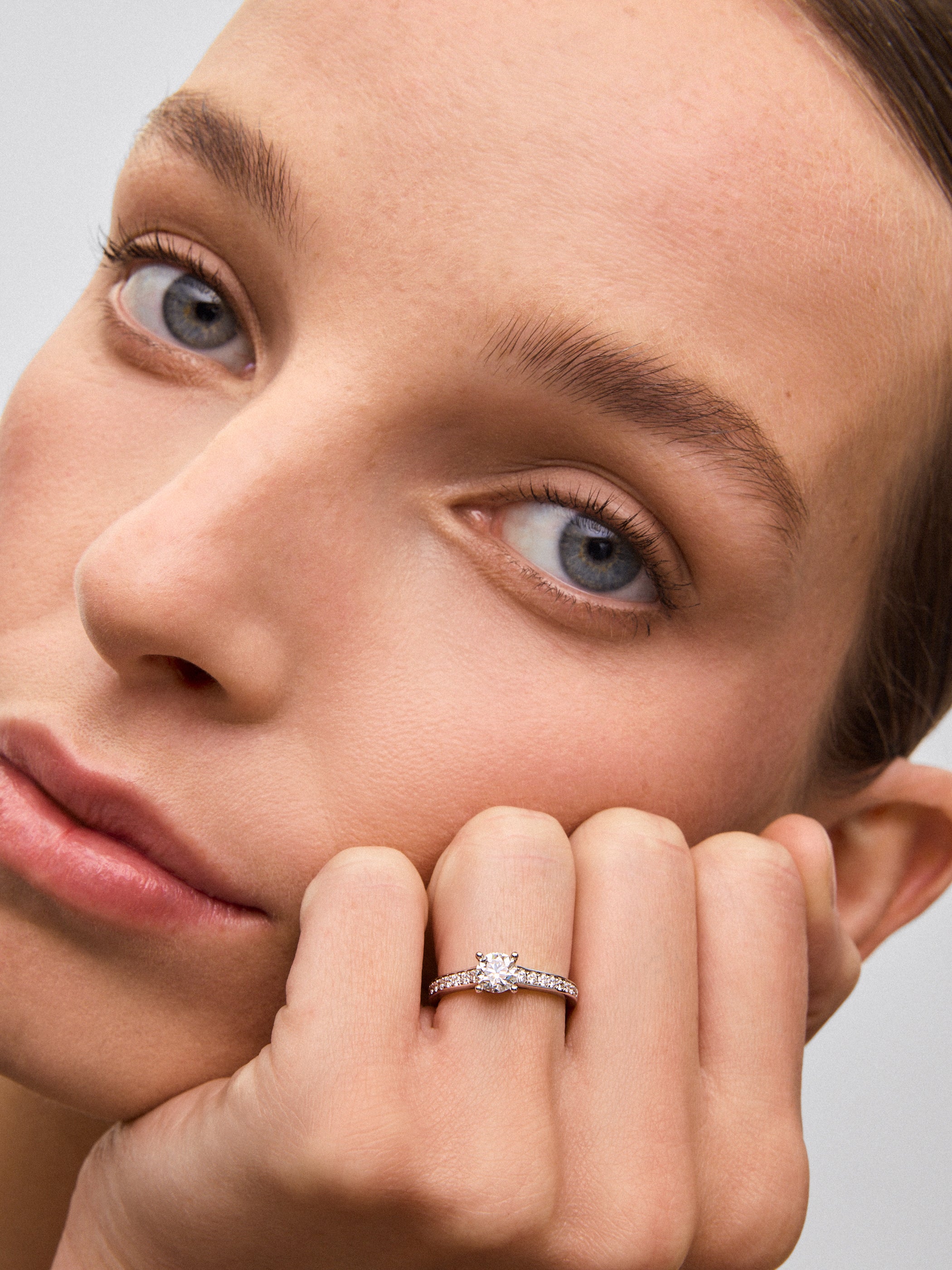 18K white gold solitaire ring with a 0.70 ct central diamond and brilliant-cut diamonds totaling 0.26 cts