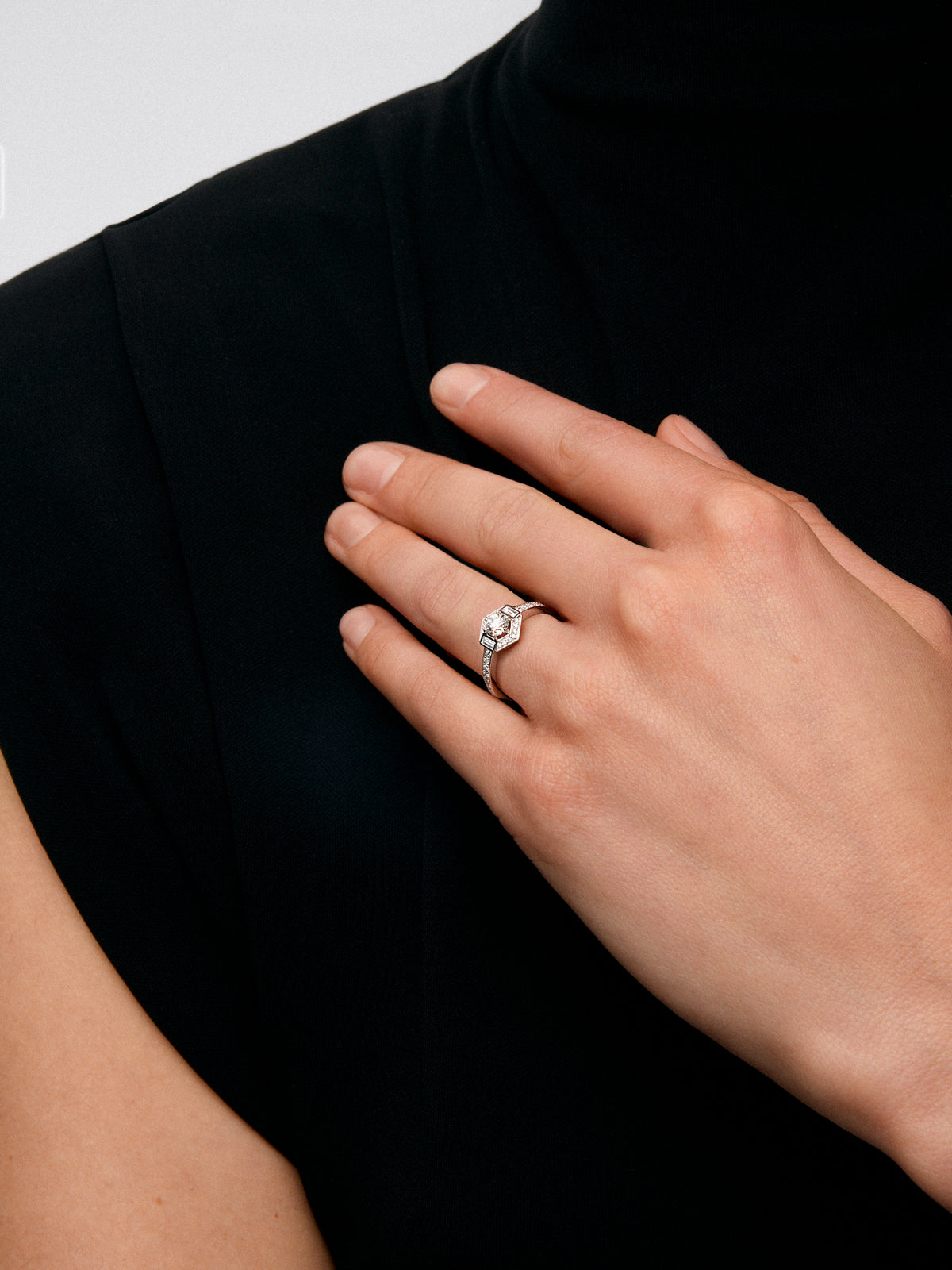 18K white gold ring with central brilliant-cut diamond of 0.4 cts and border with 2 baguette-cut diamonds with a total of 0.14 cts and 30 brilliant-cut diamonds with a total of 0.19 cts