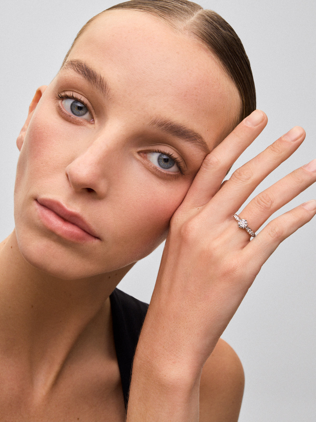 Solitaire ring in 18K white gold with a 1-carat brilliant-cut central diamond and additional diamonds totaling 0.38 cts