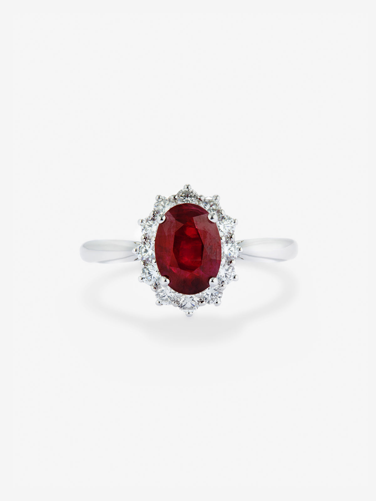 Anillo de oro blanco de 18K con rubí rojo vivid en talla oval de 1 cts y 12 diamantes en talla brillante con un total de 0,25 cts