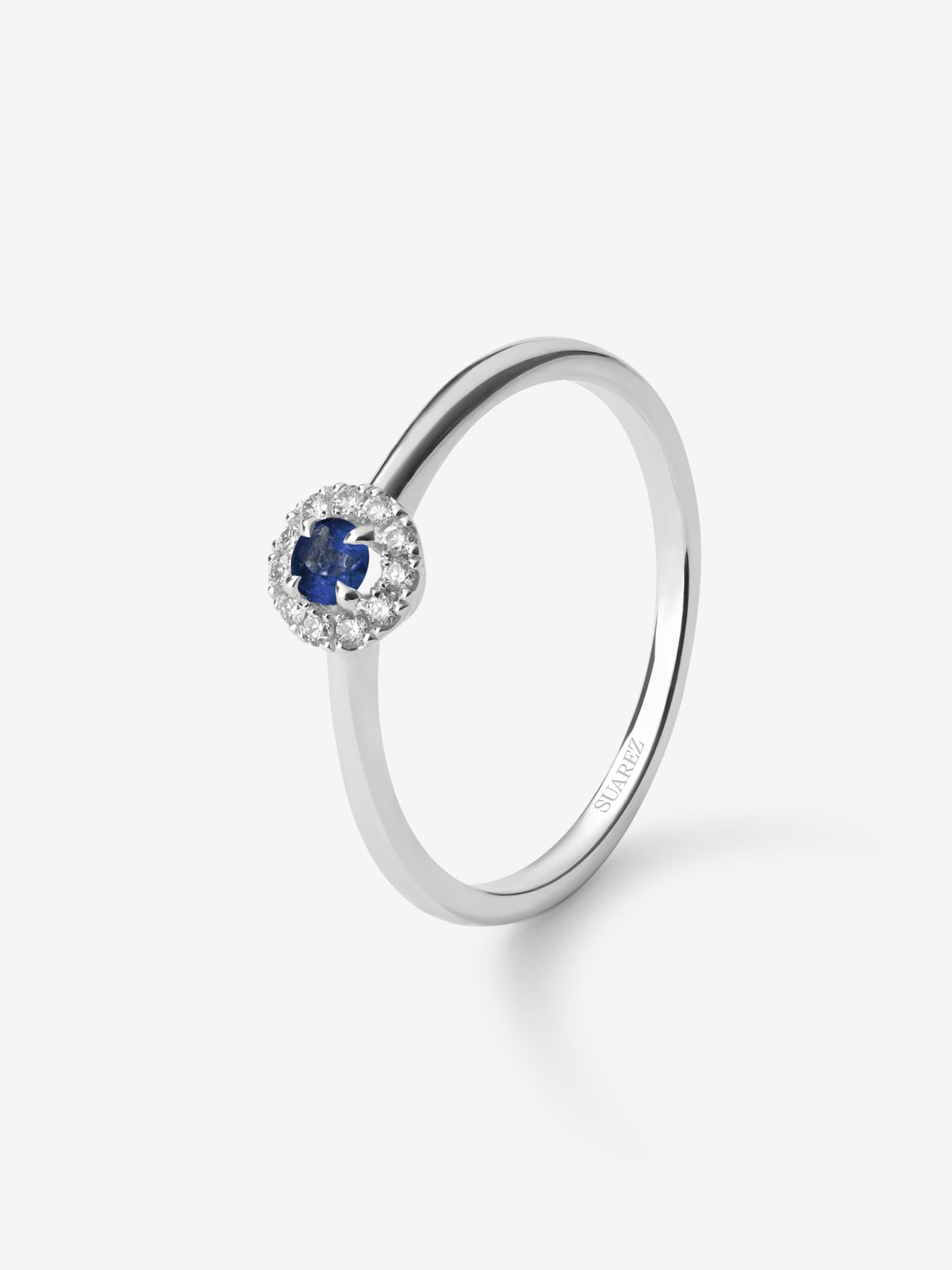 Anillo de oro blanco de 18K con zafiro azul en talla brillante de 0,2 cts y 10 diamantes en talla brillante con un total de 0,08 cts