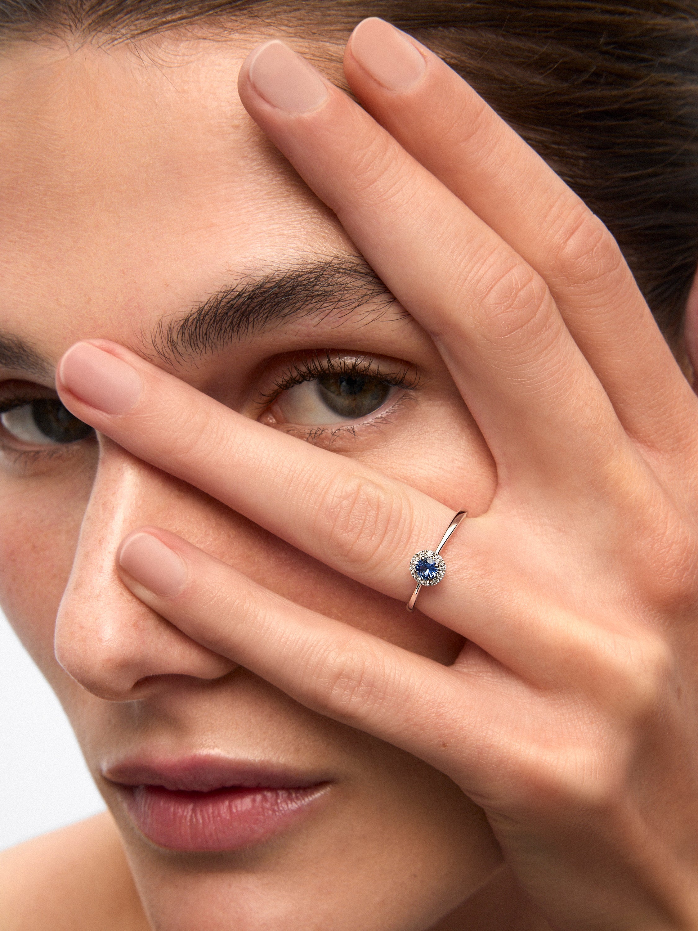 Anillo de oro blanco de 18K con zafiro azul en talla brillante de 0,2 cts y 10 diamantes en talla brillante con un total de 0,08 cts