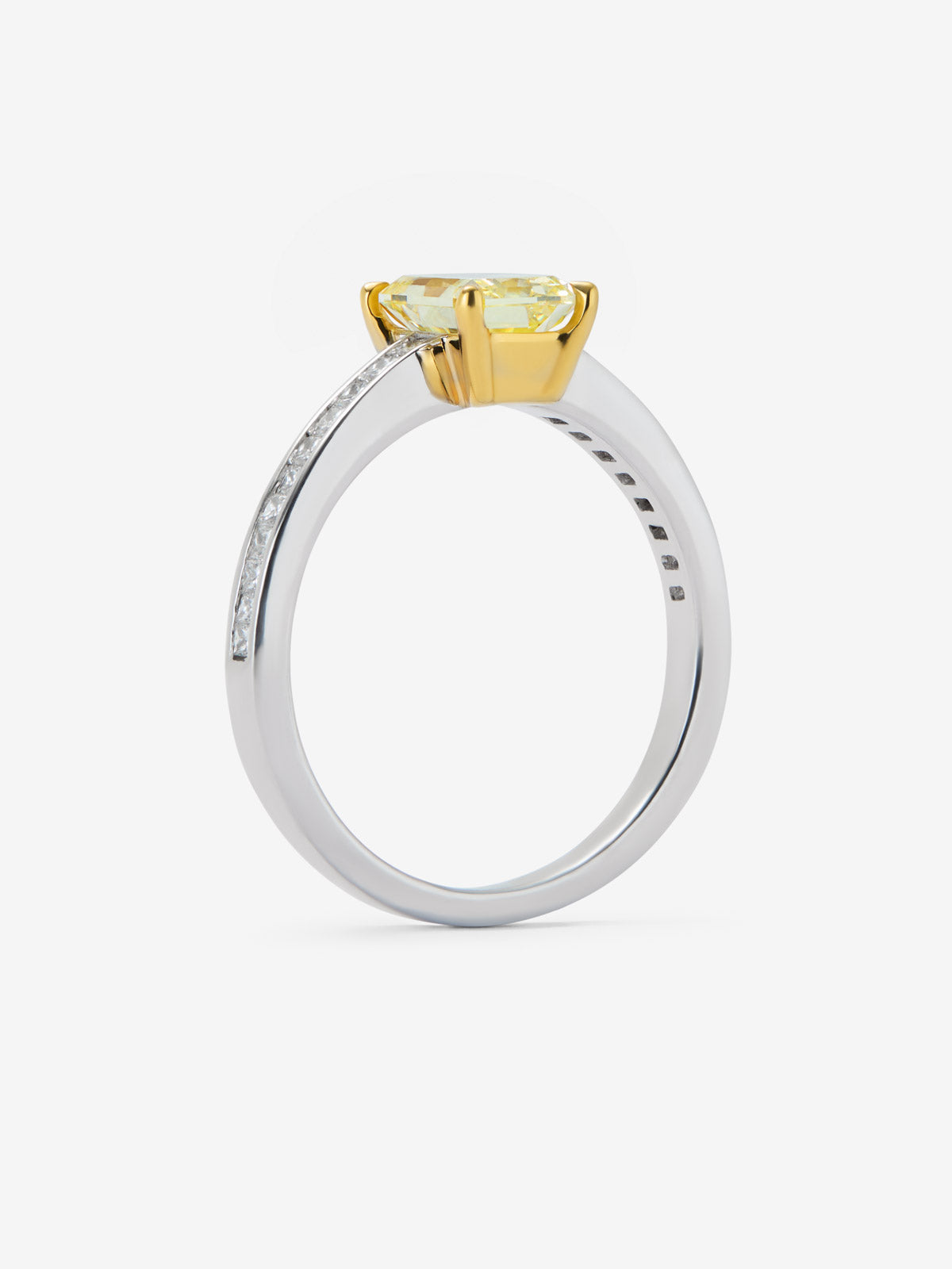 Solitaire ring in 18K white and yellow gold with 1.19ct radiant-cut Fancy Yellow center diamond and 18 brilliant-cut diamonds with a total of 0.236 cts