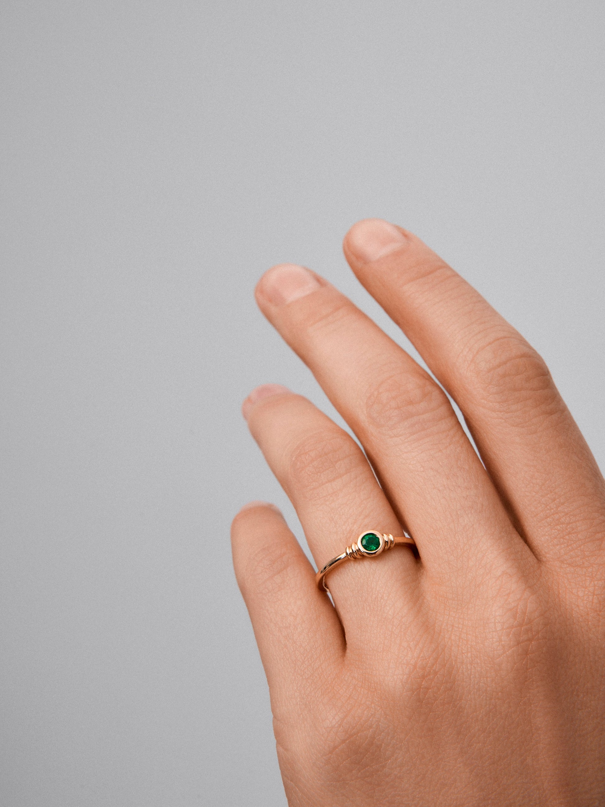 Anillo de oro amarillo de 18K con esmeralda en talla brillante de 0,12 cts