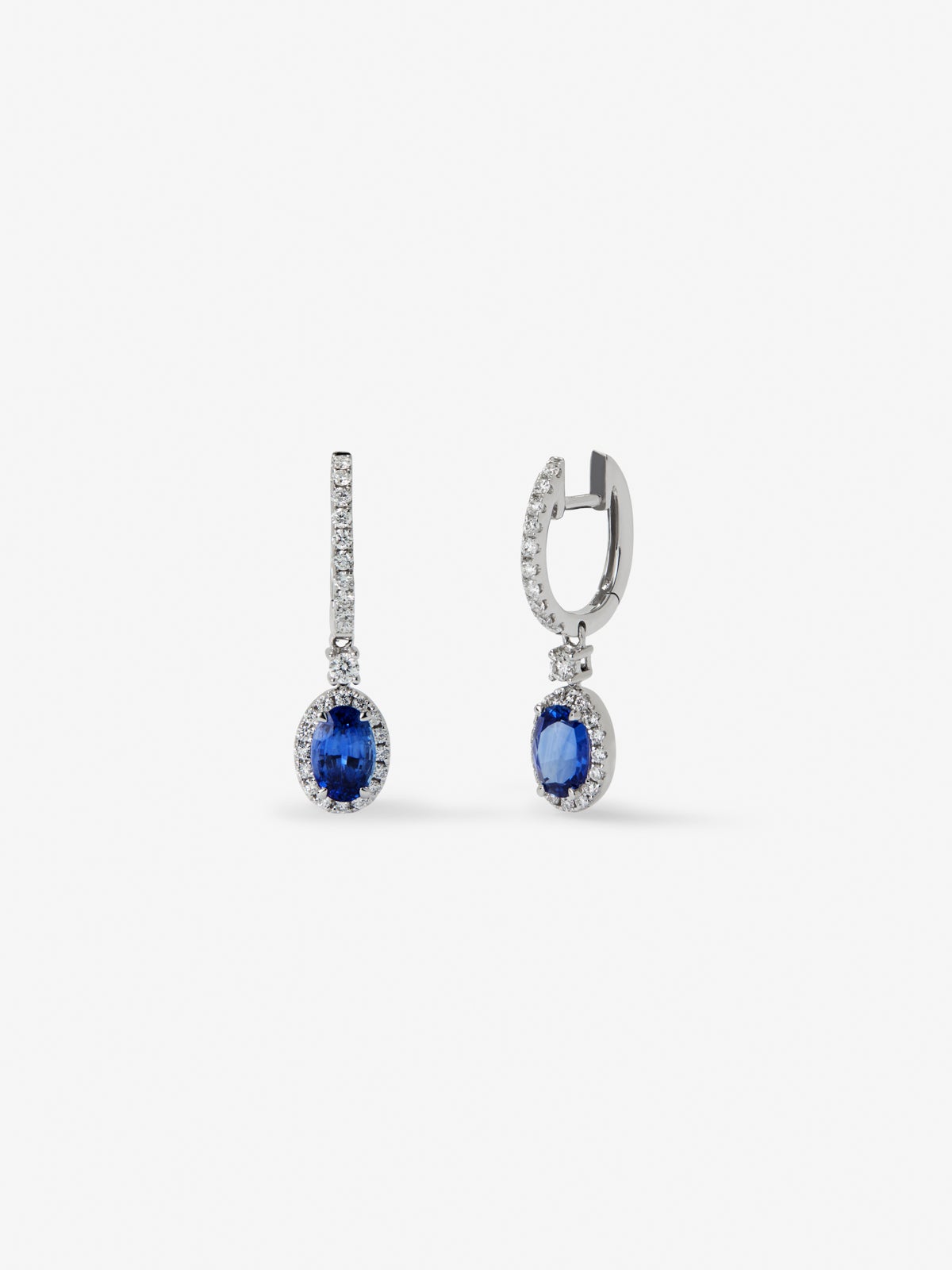 18K white gold earrings with 2 oval-cut blue sapphires with a total of 0.69 cts and 36 brilliant-cut diamonds with a total of 0.13 cts
